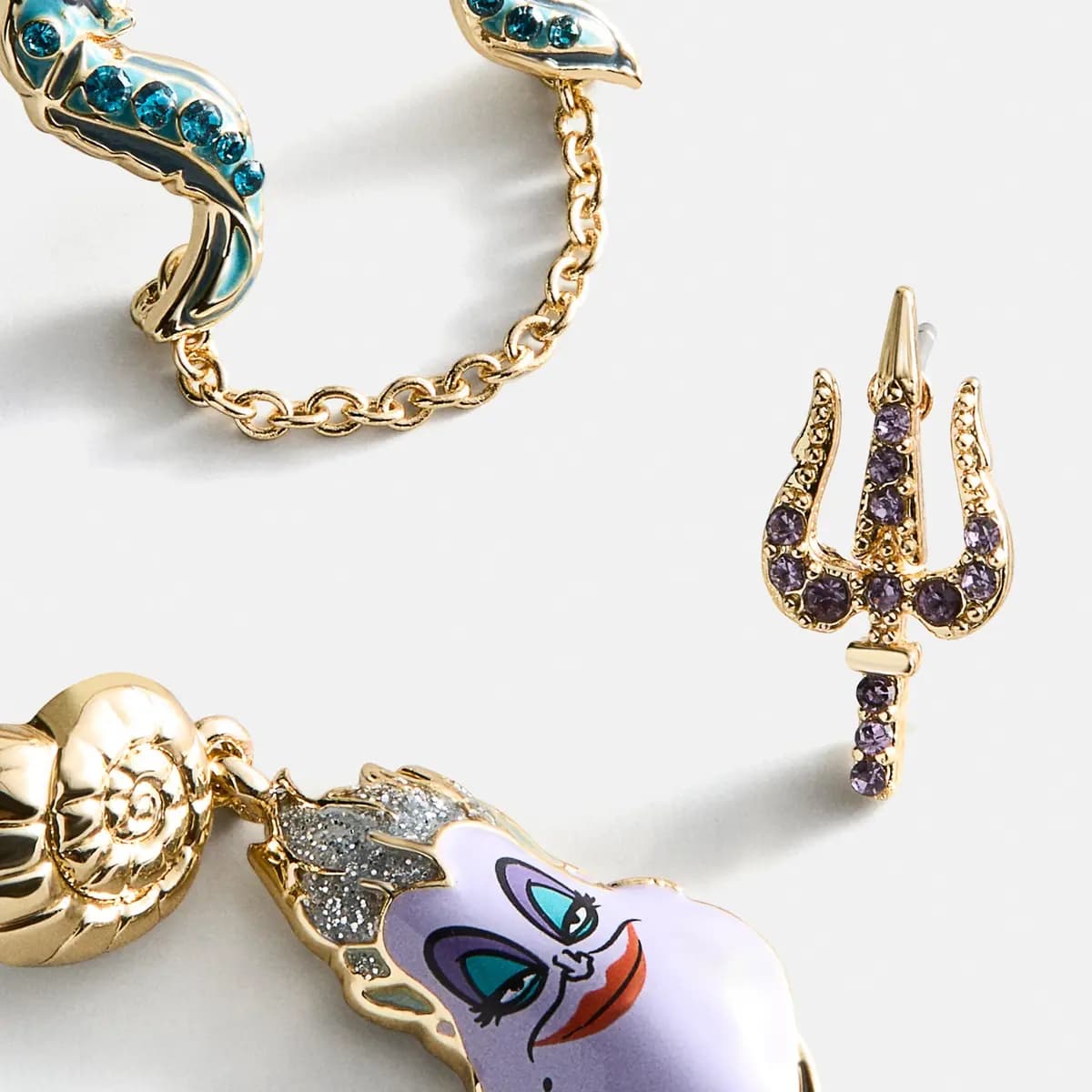 BaubleBar Disney Ursula Earring Set [1 pair of studs featuring Ursula’s trident, 1 pair of drop earrings featuring a gold s, 1 pair of double-piercing earrings featuri]