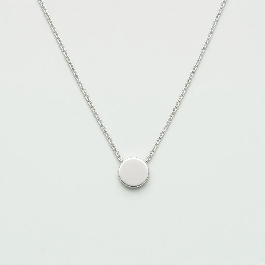 Small sterling silver disc pendant necklace with a stamped letter on a fine chain
